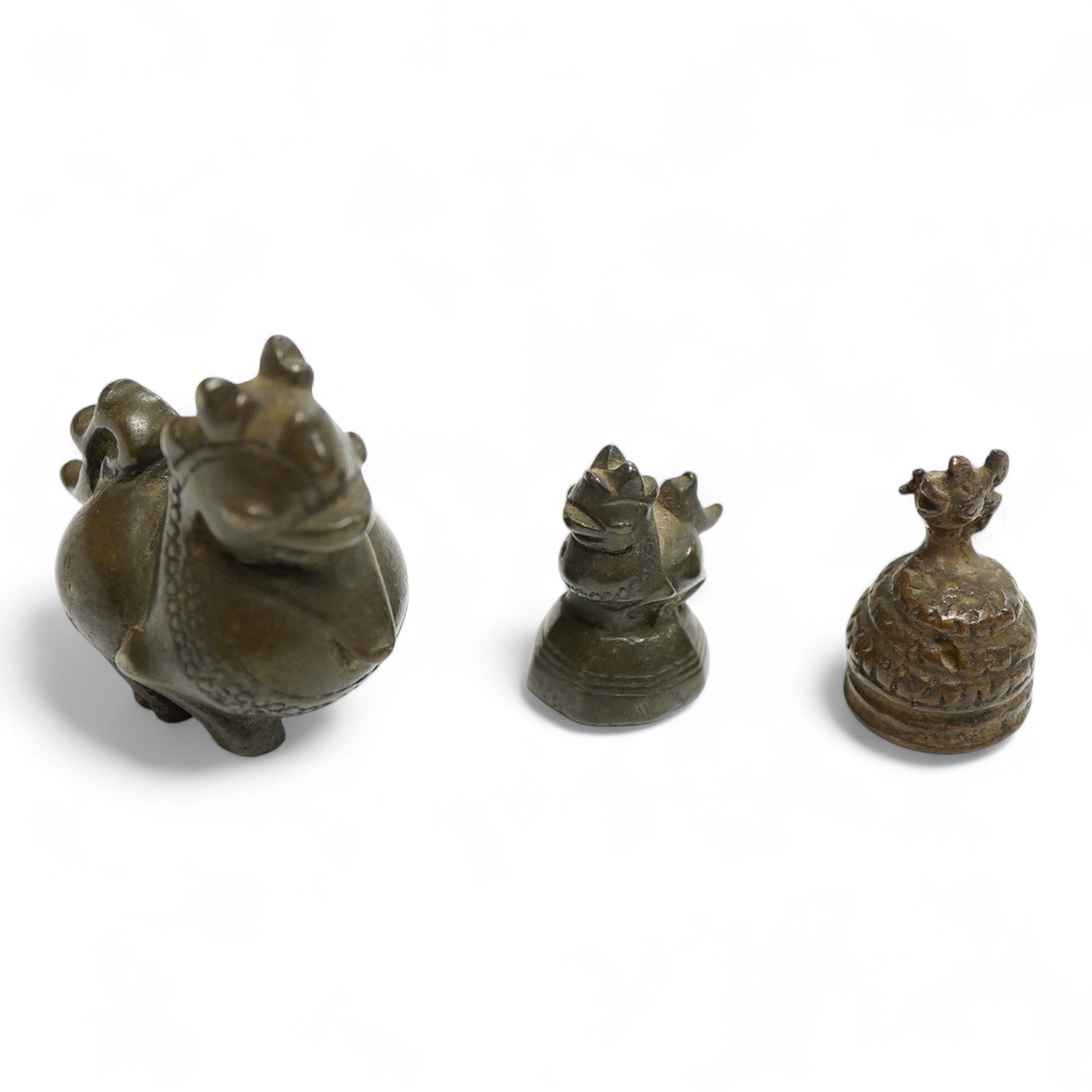 Two 19th century Burmese bronze weights, and a similar figure of a mythical beast, largest 4cm high